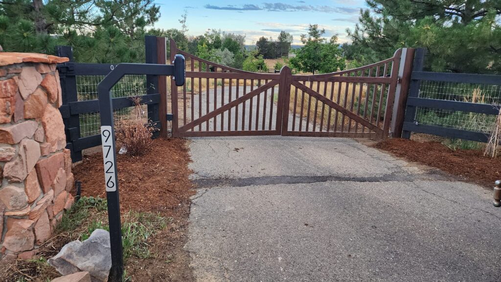 Rust-colored custom metal driveway gate