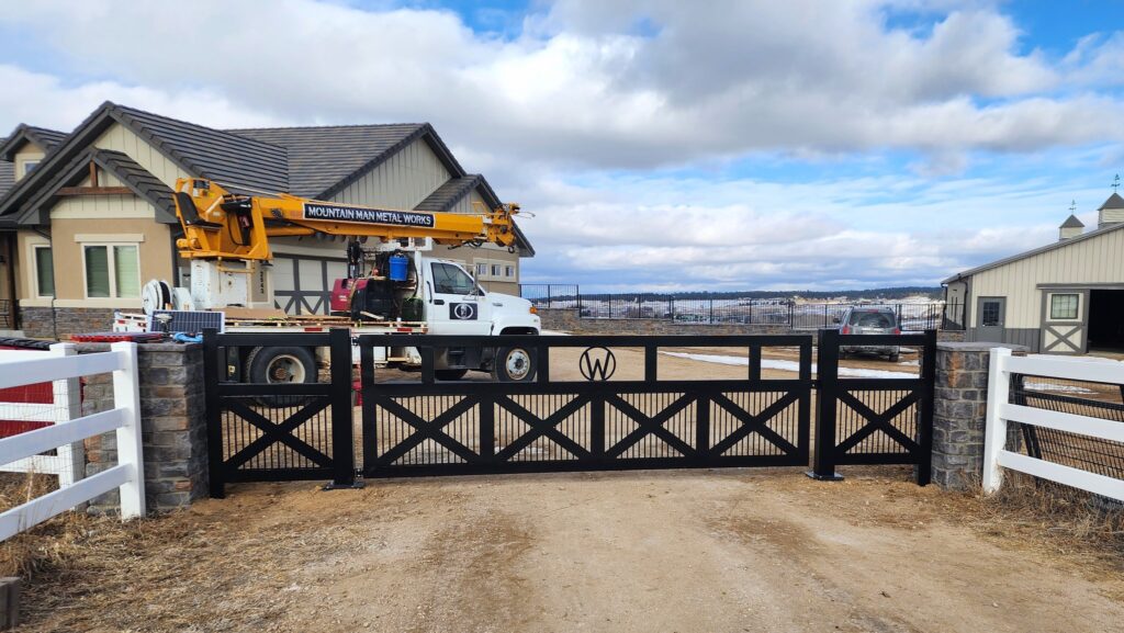 Custom black metal gate in front of a house